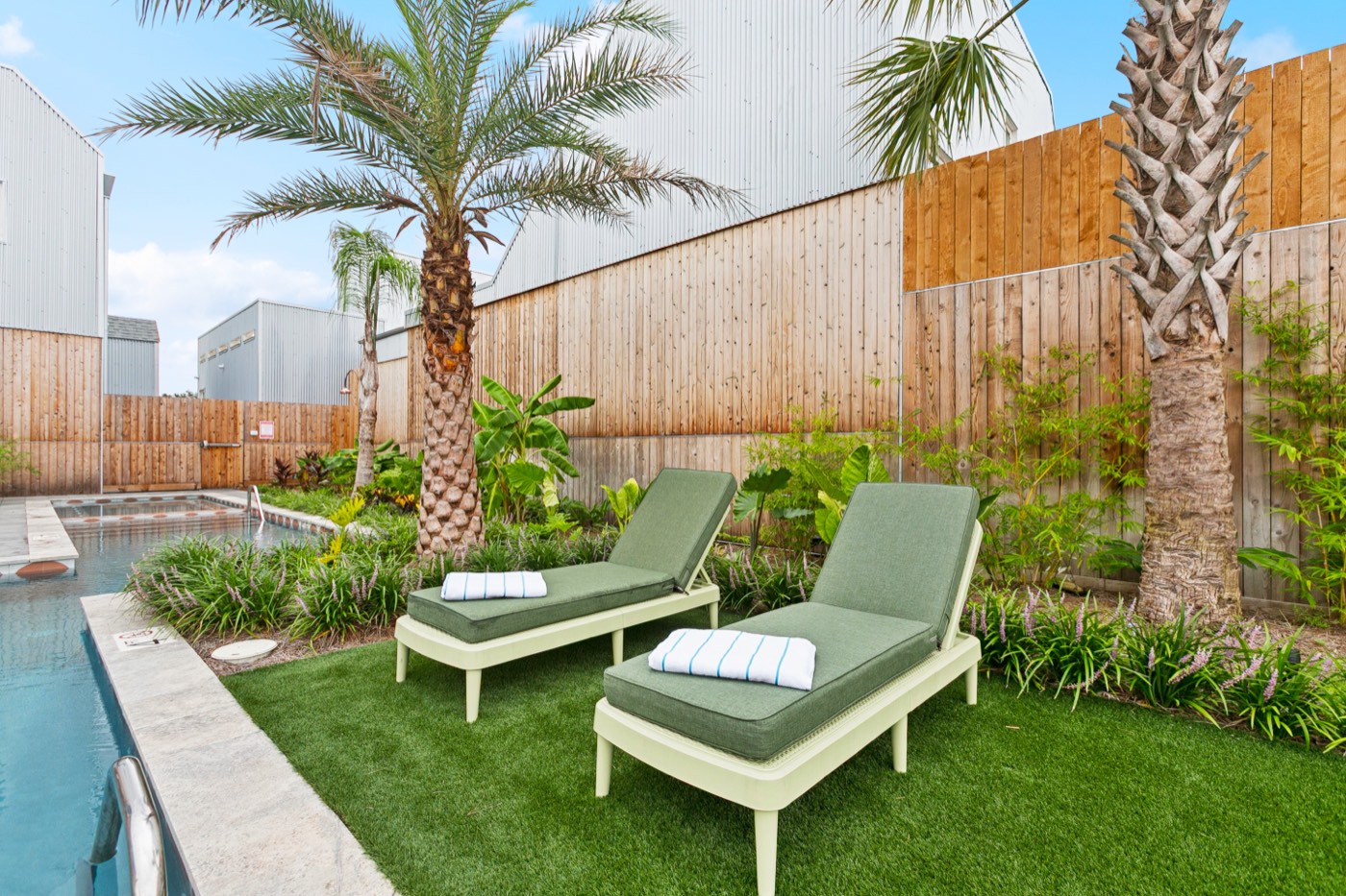 Pool loungers and palm trees at a private New Orleans group villa
