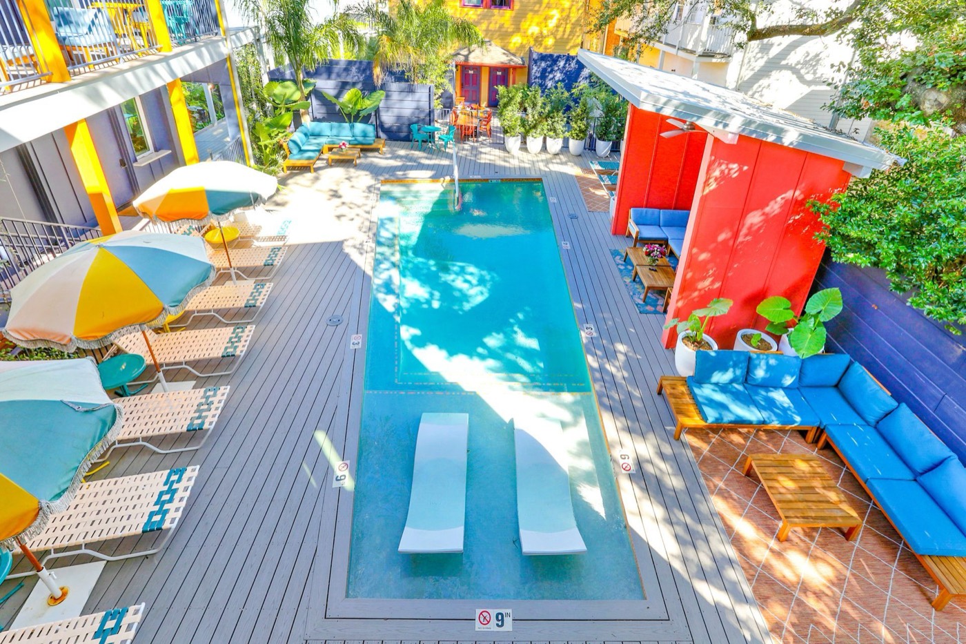 Aerial view of The Syd's colorful courtyard pool with umbrellas